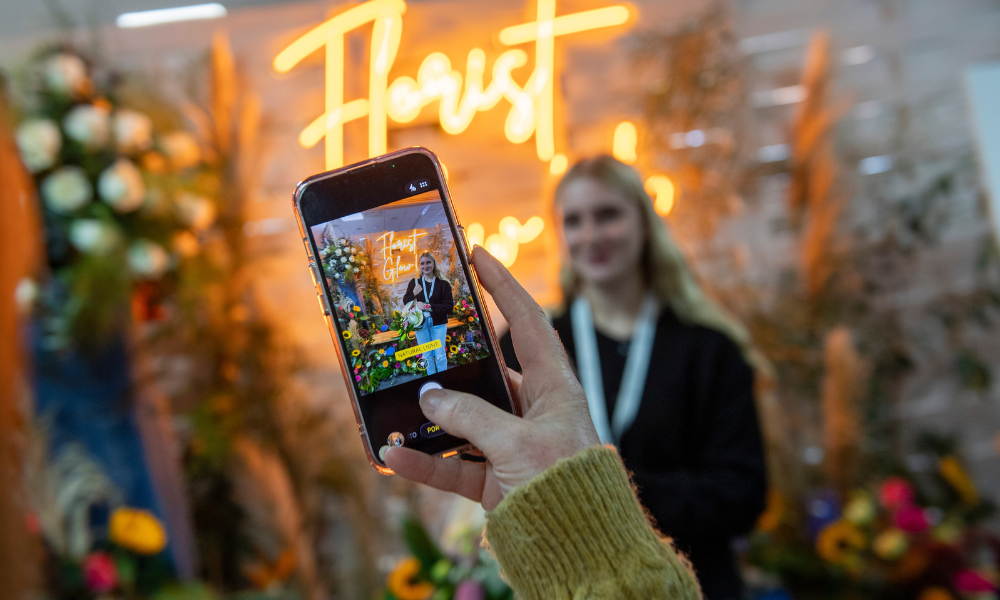 Large colourful flower installation with self being taken